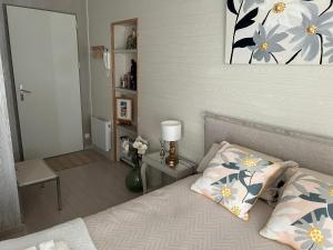 1 dormitorio con 1 cama con una pintura floral en la pared en Amarillo, en Quint-Fonsegrives