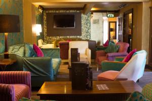 a lobby with colorful chairs and a waiting room at The Old Palace Lodge in Dunstable