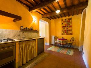 a kitchen with a sink and a stove top oven at Tuscan Charm in Greve in Le Bolle +32 photos
