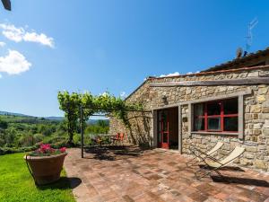 a stone house with a patio with a table and chairs at Tuscan Charm in Greve in Le Bolle
