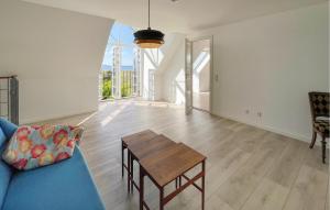 a living room with a blue couch and a table at 2 Bedroom Nice Home In Harpelunde in Harpelunde +10 photos