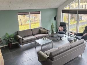 a living room with a couch and a table at 14 person holiday home in Glesborg in Glesborg