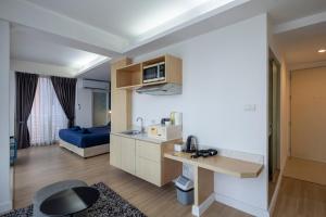 a living room with a kitchen and a bedroom at GP House Express Sukhumvit 81 in Bangkok