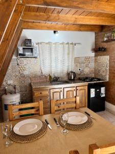 a kitchen with a table with two plates on it at ALPINAS DeL MONTE in Cortaderas