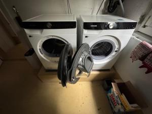 a washing machine and a washer in a kitchen at Studio apartment - Park view - for 2 guests in Thun