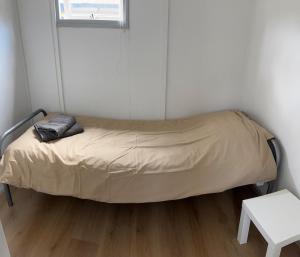 a bed in a room with a pillow on it at Chalet with nice garden in Anloo