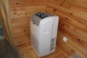 a white heater in a corner of a room at Baie de Somme Bus in Saint-Blimont