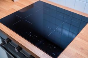 a tablet on top of a stove in a kitchen at Flex SelfCheckIns 146 - Zagreb - 1 Bedroom - Loggia - WIFI in Zagreb