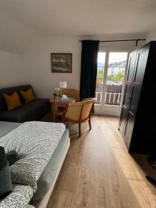 a bedroom with a bed and a table and a couch at Apartment Spiez - Lake view in Thun +19 photos