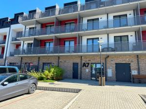 a car parked in front of a building at Lipno Loft - Korzo in Lipno nad Vltavou