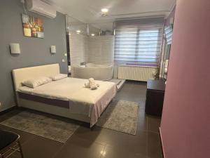 a bedroom with a bed and a bath tub and a sink at Bela Ruza in Belgrade