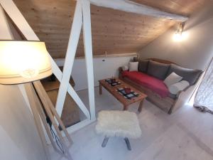 a living room with a couch and a table at LES AGUDES Télécabine 10min à pied in Cauterets