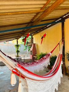 a hammock hanging from a building in a room at casa de veraneio jalapão in São Félix do Tocantins +14 photos