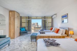a living room with two beds and a couch at Luxury Villa Sea Views Heart of St Julians in St Julian's +91 photos