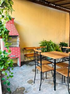 a patio with a table and chairs and a piano at casa de veraneio jalapão in São Félix do Tocantins