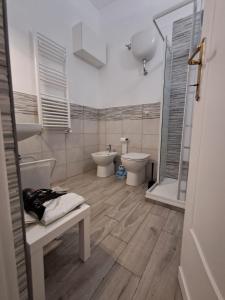 a white bathroom with two toilets and a shower at la gatta bianca in Marino