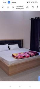 a bedroom with a bed with a comforter on it at Hotel Avtar Palace in Jāmb