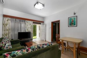 a living room with a couch and a table at Crane Serviced Apartments in Entebbe