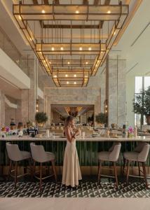 a bride and groom standing in front of a bar at Palace Beach Resort in El Alamein +37 photos