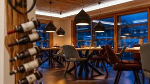 a dining room with a bunch of wine bottles at Monaco Sport Hotel in Santo Stefano di Cadore +101 photos
