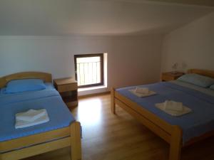 a room with two beds and a window at Sun Apartments in Tivat
