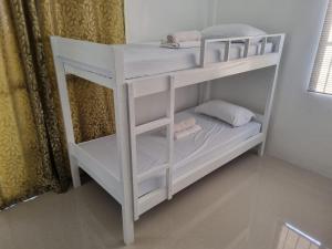 a white bunk bed in a room at UB HOME in Dauis