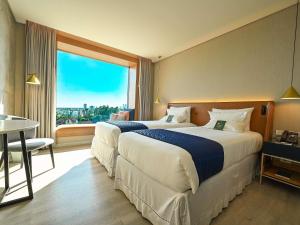 Giường trong phòng chung tại Novotel Santa Cruz De La Sierra
