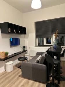 a living room with a couch and a table at A little love nest in Brussels