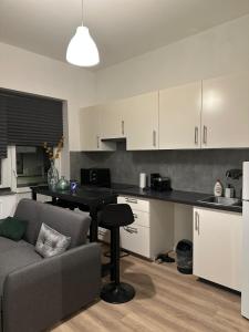 a kitchen and living room with a couch and a table at A little love nest in Brussels