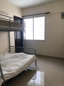 a bedroom with a bunk bed and a window at 2BHK Fully Furnished at Pukkattupady Cochin in Kakkanad