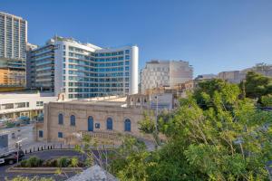 an old building in a city with tall buildings at Luxury Villa Sea Views Heart of St Julians in St Julian's