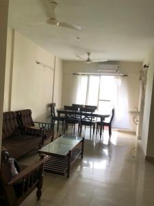 a living room with a couch and tables and a window at 2BHK Fully Furnished at Pukkattupady Cochin in Kakkanad