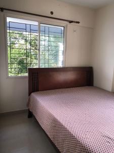 a bedroom with a bed in front of a window at 2BHK Fully Furnished at Pukkattupady Cochin in Kakkanad
