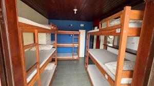 a room with four bunk beds in a house at Hostel Arraial in Arraial do Cabo