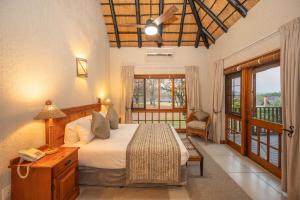 Kruger Park Lodge Unit No 304 في هازيفيو: غرفة نوم مع سرير كبير وشرفة +36 صورة