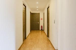 an empty hallway with two doors and a fire hydrant at Collection O BTM Layout Near Madiwala Lake Formerly Q Rooms in Bengaluru