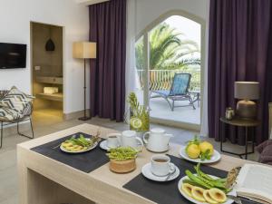 a living room with a table with food on it at Baia Delle Zagare - Handwritten Collection in Mattinata