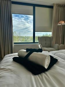 a hotel room with a bed with a chair and a window at Prestige Hotel in Stalowa Wola