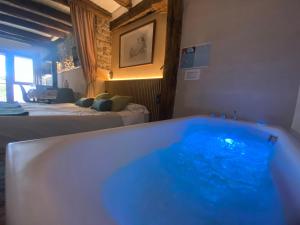 a bath tub in a room with two beds at Country loft Zarautz- San Sebastián in Aia