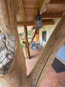 a view of a large tree trunk in a house at Domek Marianówka PRYWATNA BALIA OGRODOWA in Kampinos