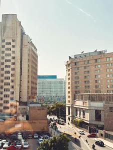 a city with cars parked in a parking lot at Marhaba Inn Hostel in Cairo