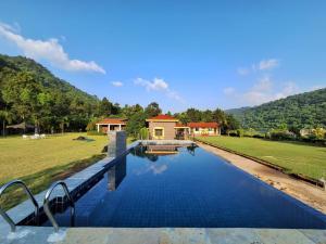 a villa with a swimming pool and a house at Eco Adventure Resorts Khhairabera in Bāghmundi