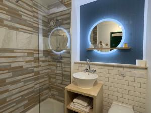 a bathroom with a sink and a shower with a mirror at ibis Styles Paris Hippodrome de Vincennes in Joinville-le-Pont