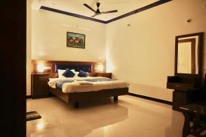 a bedroom with a bed and a ceiling fan at Nivaa Stays - Near JIPMER in Pondicherry