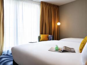 a hotel room with two beds and a window at Mercure Amsterdam North Station in Amsterdam +61 photos