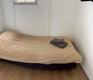 a small bed in a corner of a room at Chalet with nice garden in Anloo in Anloo