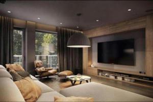 a living room with a couch and a tv at Luxary Home Marriot Marquis in Baku