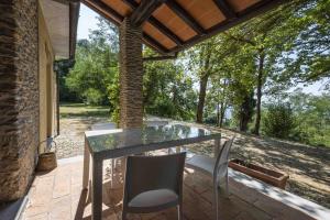 a glass table and chairs on a patio at Villa Alexandra by MMega in Riomagno