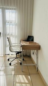 a desk with a chair and a laptop on it at Luxury Two-Story Loft - Beautiful Golf Course Views in Roodepoort