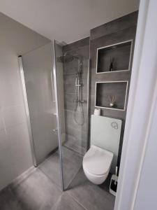 a bathroom with a shower with a toilet and a shower at 5,5 pc apartment, garden but Pool only upon request in Avry +11 photos